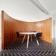 Revamped Barcelona house features herringbone floors and a covert dining area