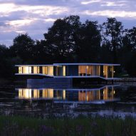 AUM builds curving concrete and glass residence on the surface of a lake