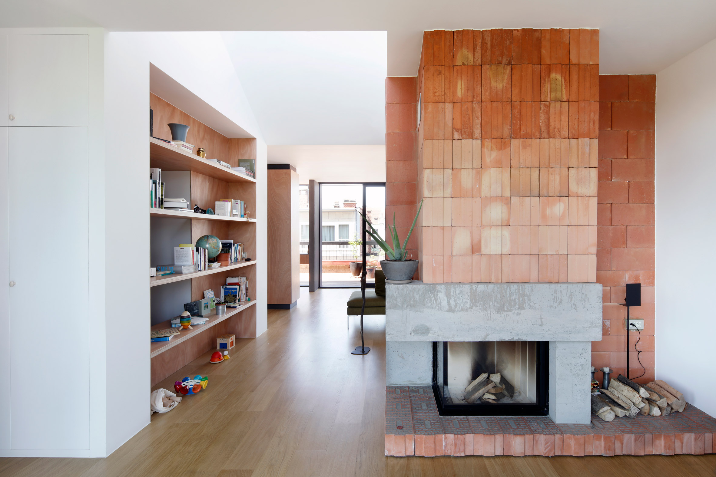 Alvar Aalto inspired the orange fireplace in this Brussels roof 