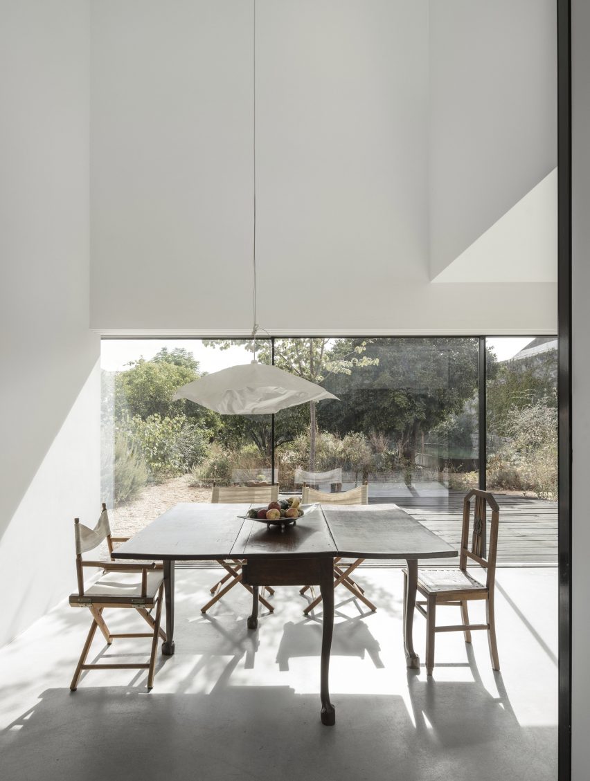 White-walled dining room of Red House by Extrastudio