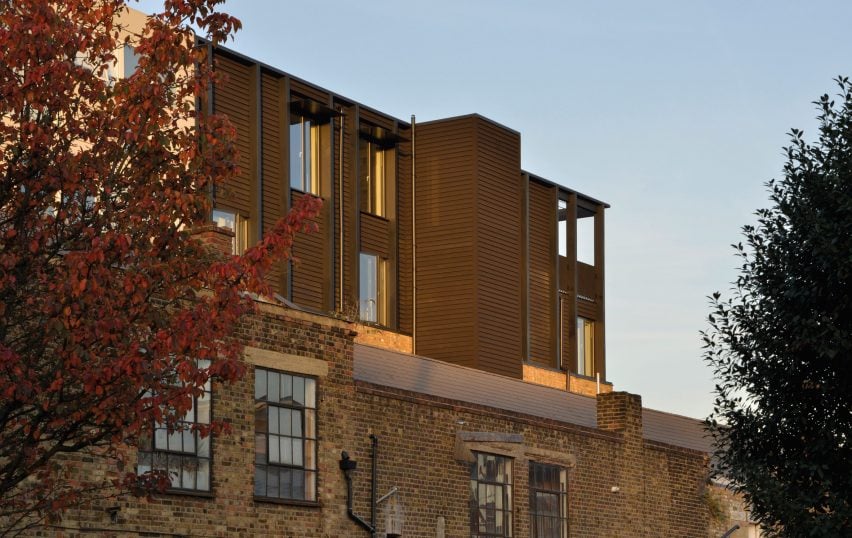 Simon Conder Associates has placed an extension clad in black-stained timber on top of a former warehouse in east London.