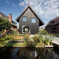Dutch architect Chris Collaris has completed a house in Amsterdam clad entirely in blackened timber and featuring an asymmetric gabled roof.