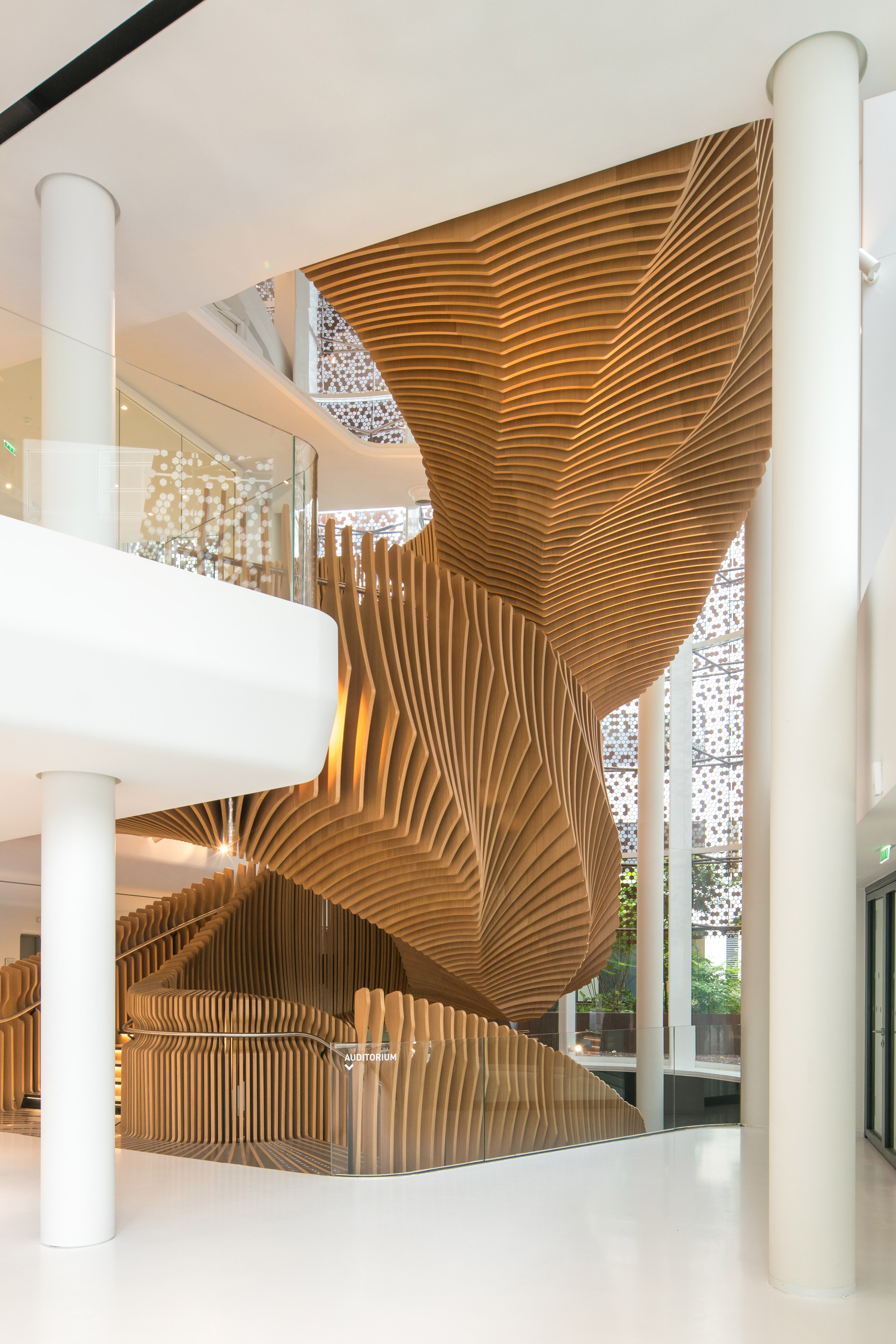 Ora Ïto uses hundreds of wooden slats for snaking oak stair at LVMH offices