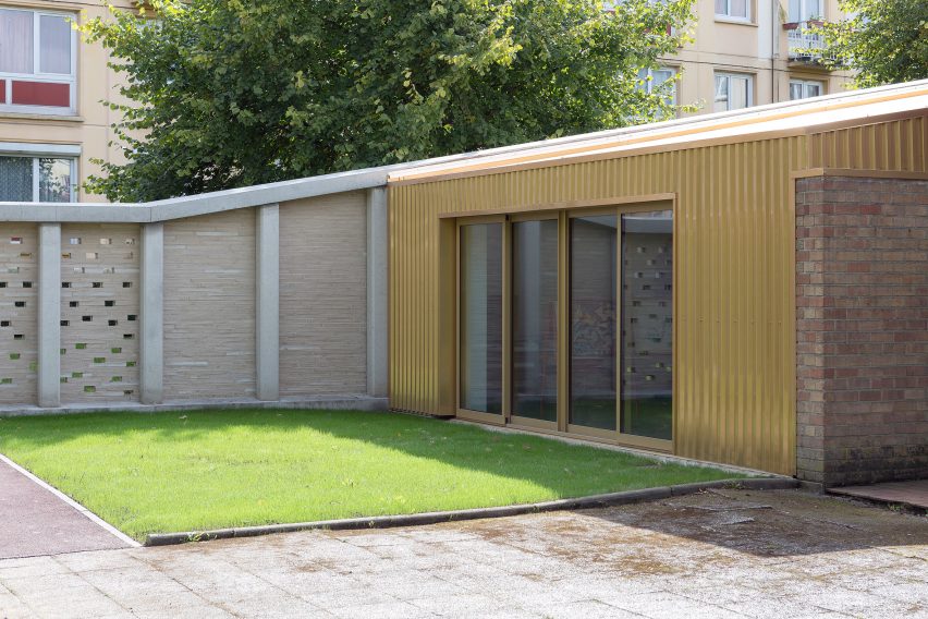 LT2A's brick school extension features porthole-like screens and gold-hued surfaces