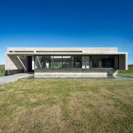 Reflecting pool fronts linear concrete house in Argentina by Luciano Kruk