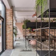 The smooth surface and soft-pink hue of a newly plastered wall provided the starting point for the design of communal spaces at this new creative hub in east London by local studio Sella Concept.
