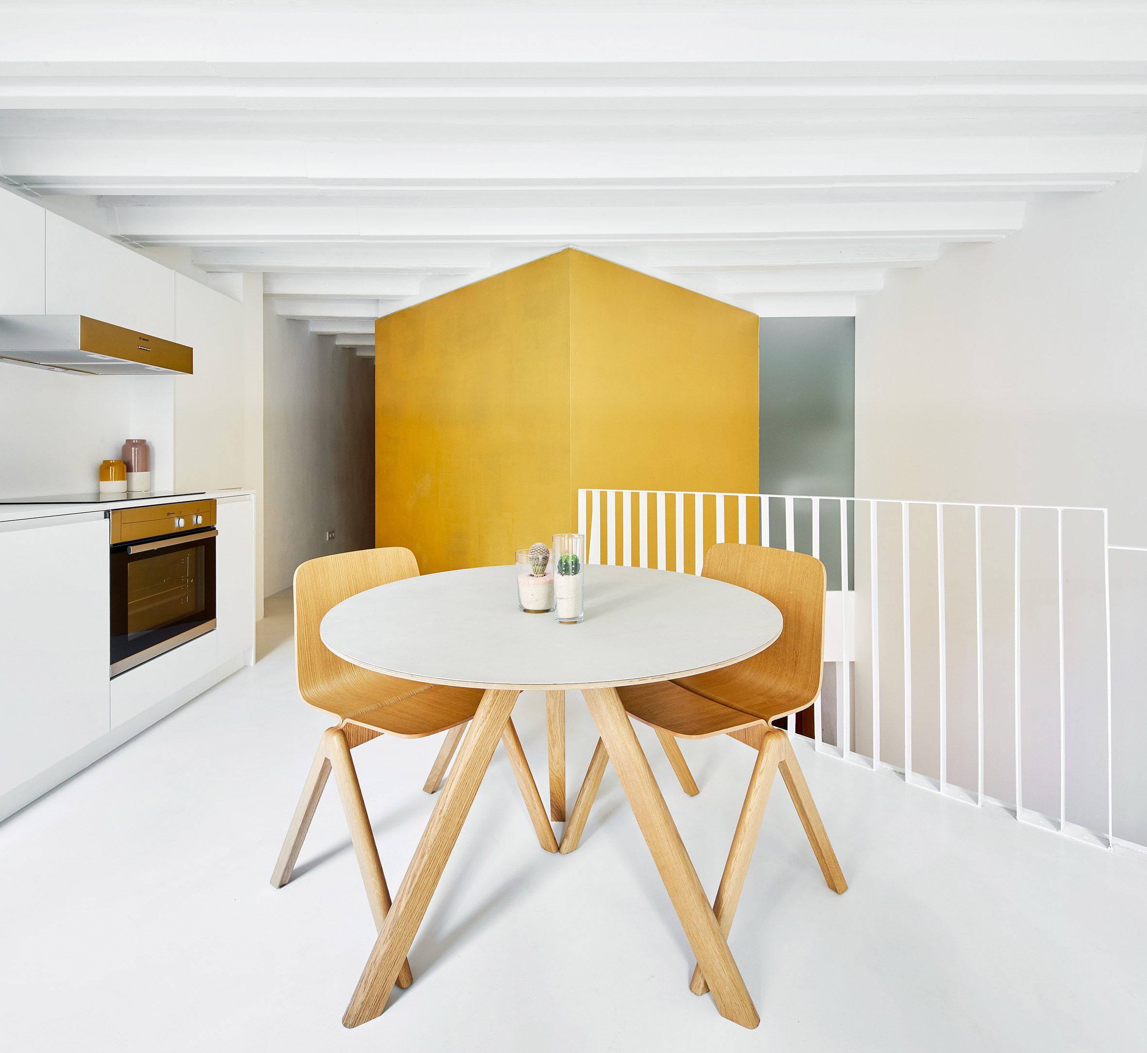 Raúl Sánchez Architects creates duplex apartment with golden cubes at its centre