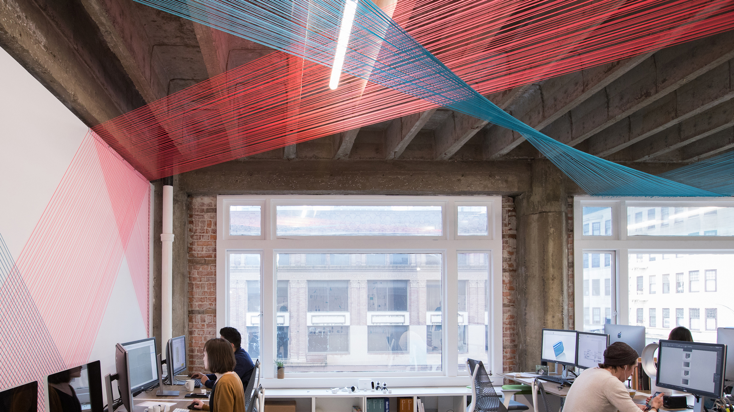 Colourful strings weave through offices of Californian design agency