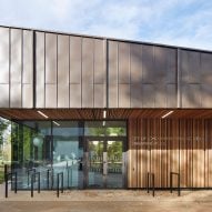 British firm Hawkins\Brown has completed a swimming-pool building at a school in Surrey, England, featuring an exposed timber frame that incorporates windows looking out onto the surrounding woodland.