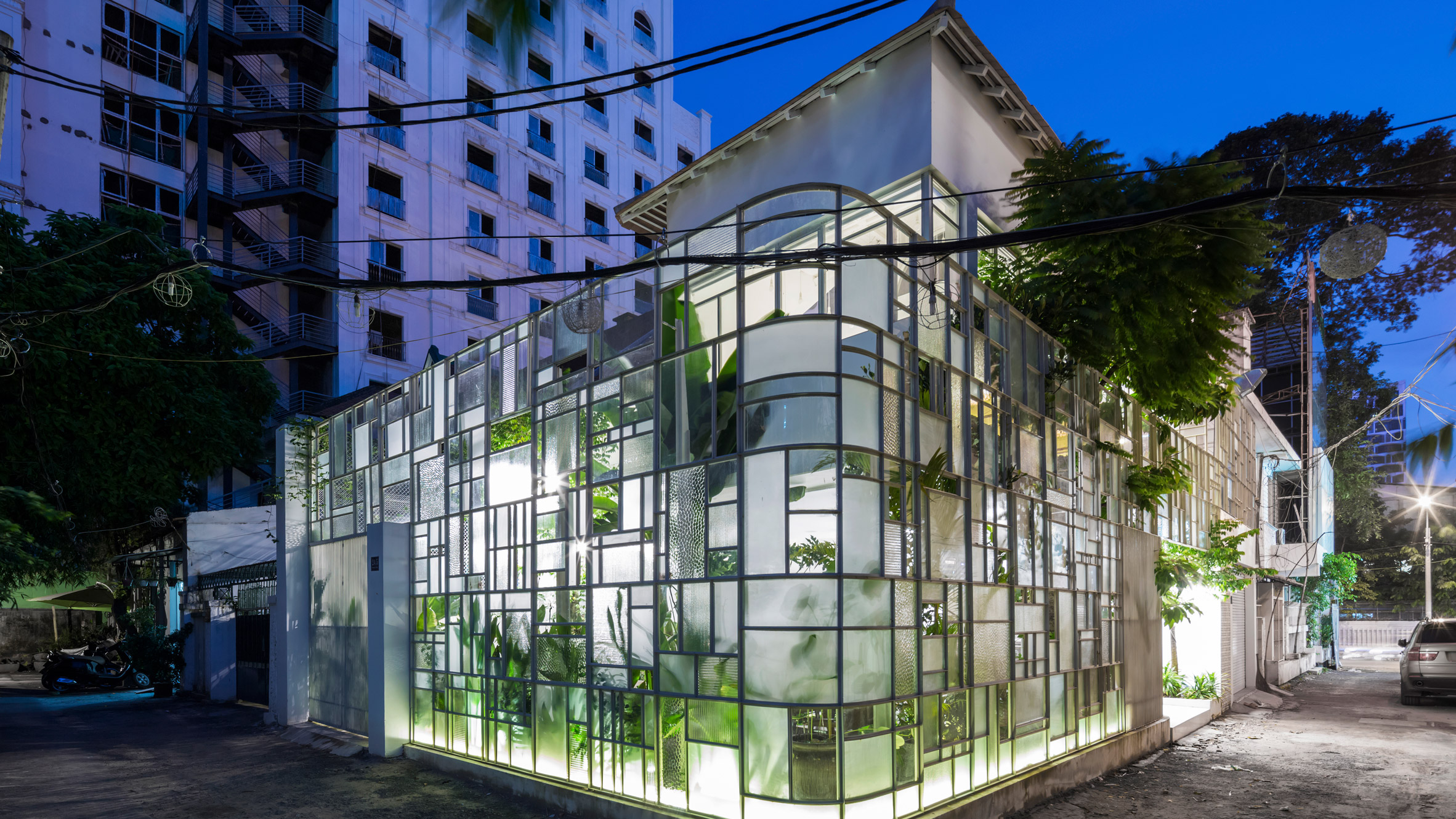 A+H architects wraps vietnam café with large, rotating glass doors