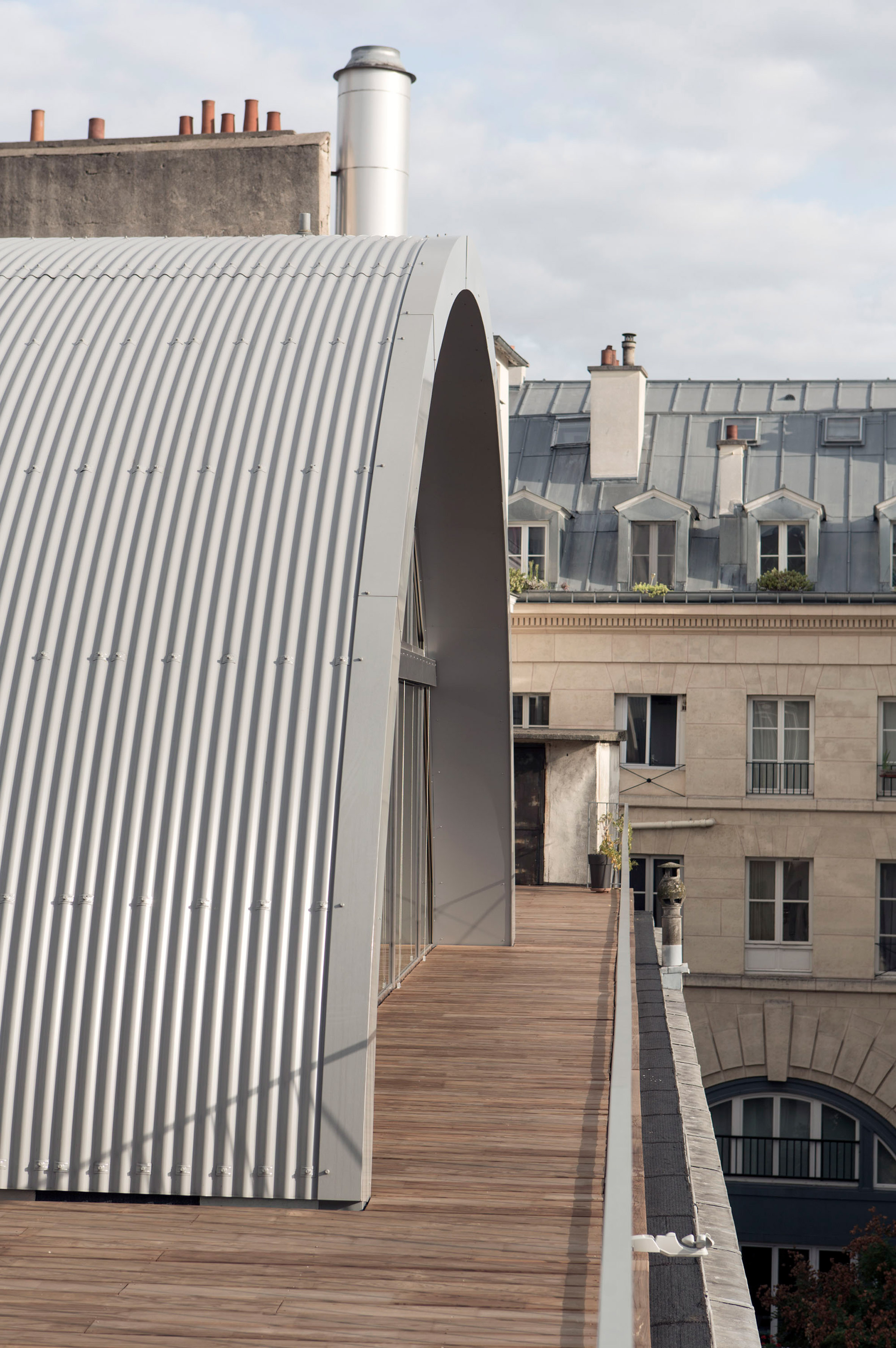 Post Office Architectes adds vaulted roof extension to Paris apartment for a photographer