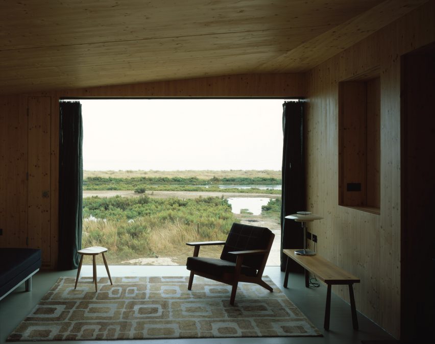 Living room with large window overlooking saltmarshes