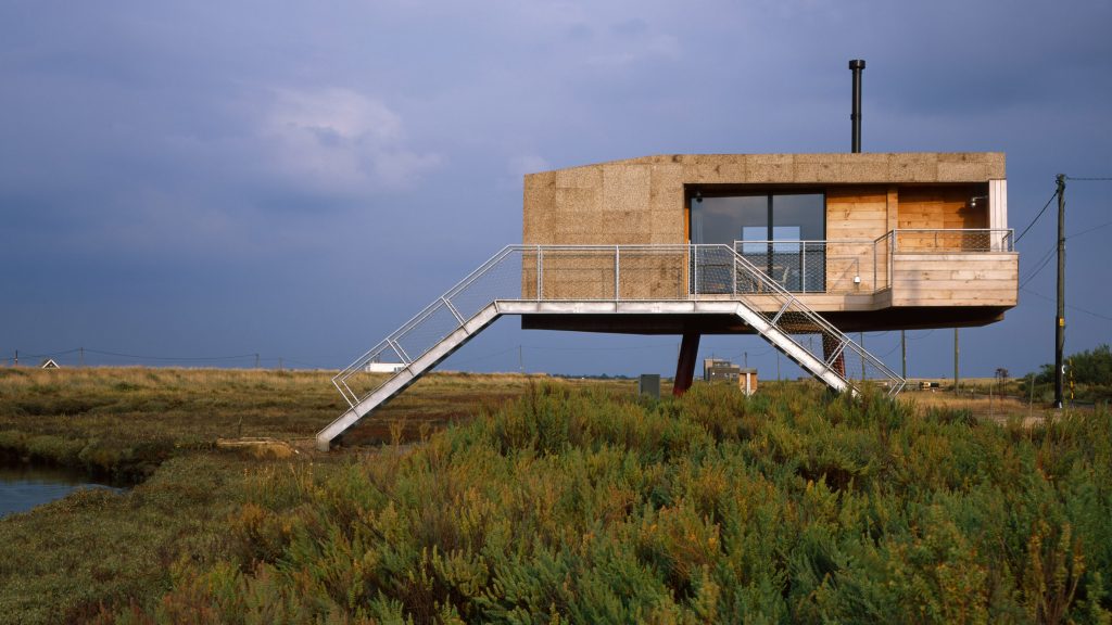 Small Boat Next to House on Stilts