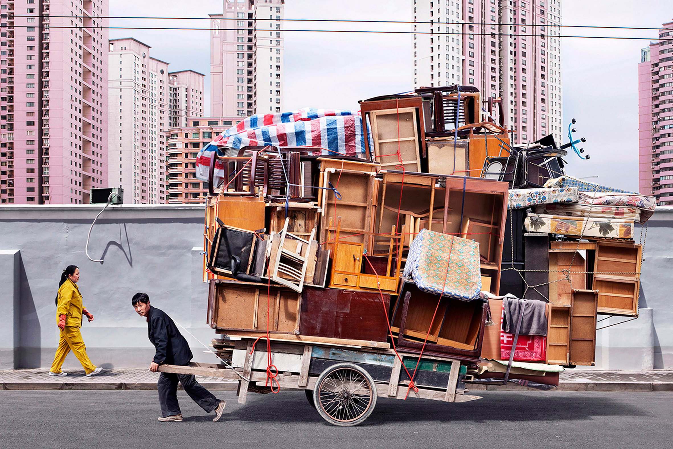 Workers carry impossible furniture loads in Alain Delorme's Totems photographs