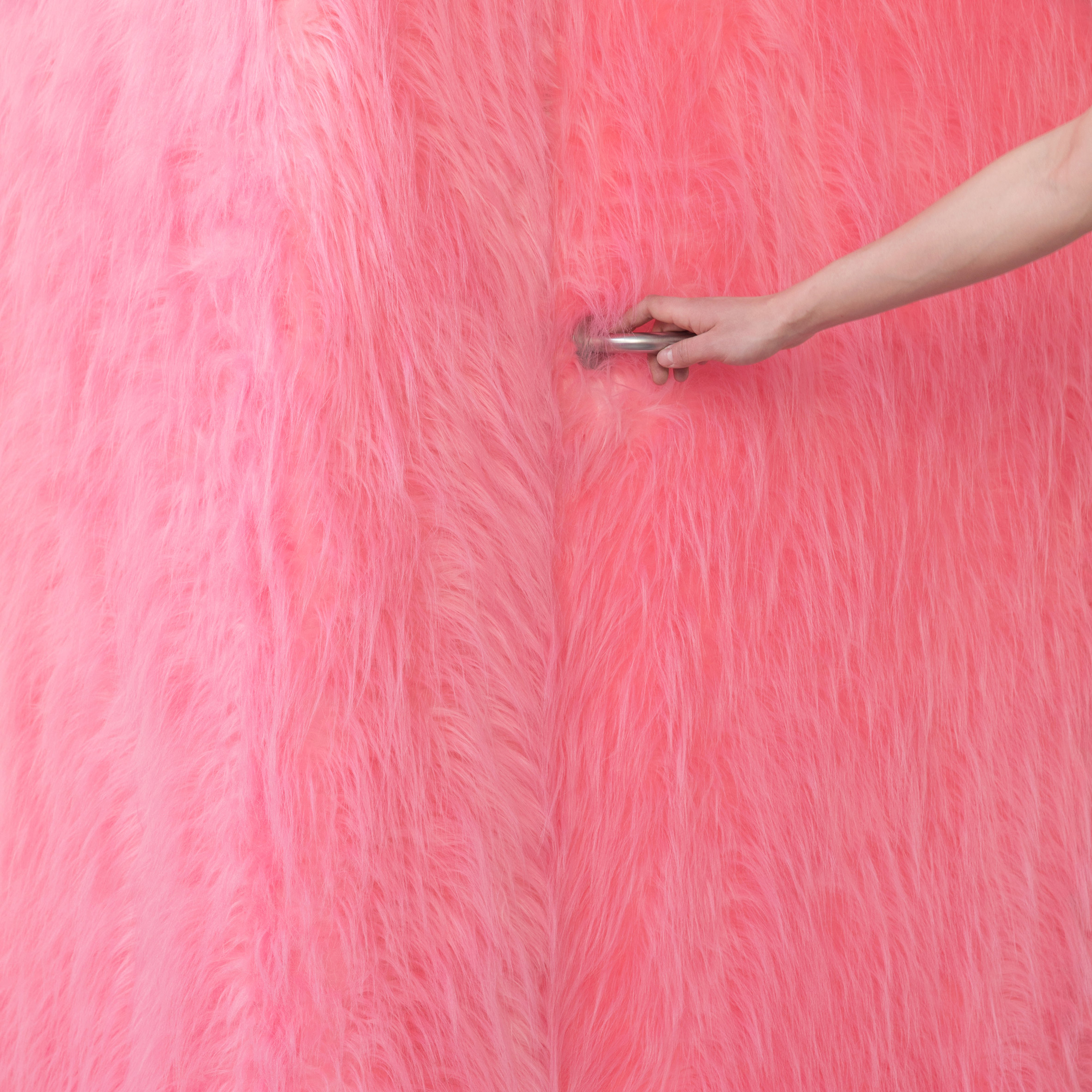 Pink furry walls and vibrant yellow surfaces brighten Russian clothing store