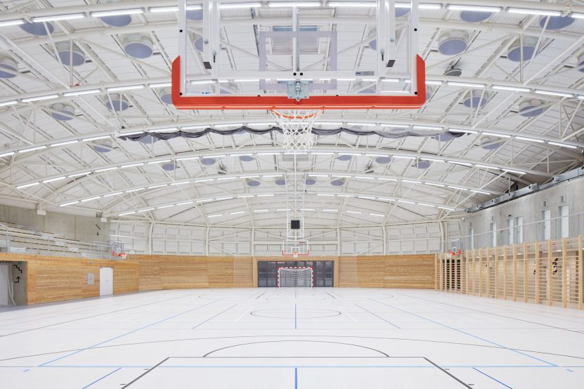 The sports hall designed by local architecture office Sporadical adjoins a recently modernised and extended primary school in the town of Dolní Břežany