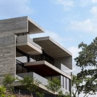 Board-marked concrete house by Paz Arquitectura sits against a hill in Guatemala