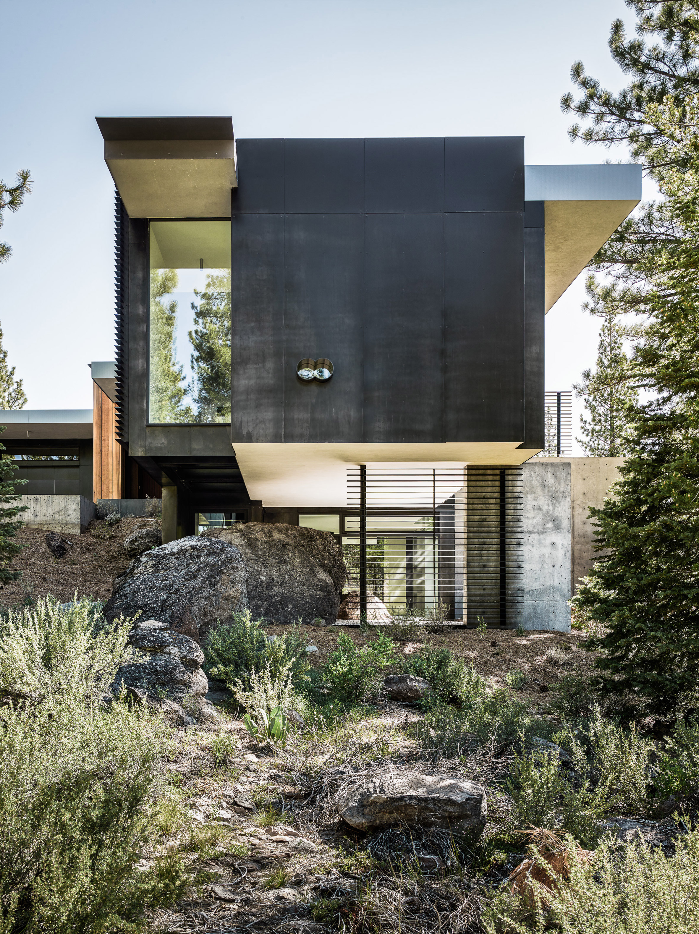 Creek House by Faulkner Architects preserves boulders on steep site in California