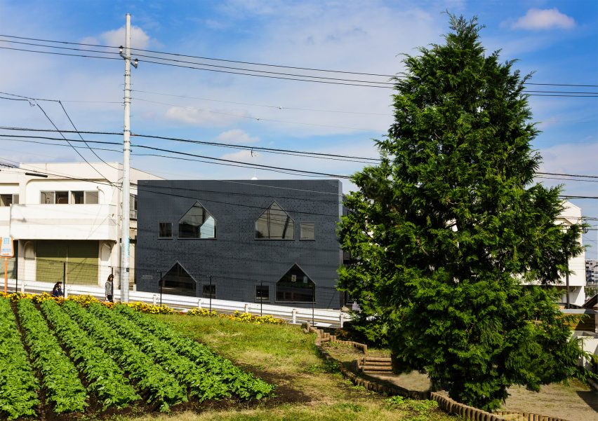 House-shaped windows puncture perforated-metal facades of Yokohama nursery
