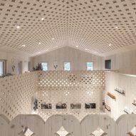 Pedevilla Architects lines cookery school with perforated timber panels