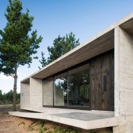 Luciano Kruk combines blackened wood with concrete for Equestrian House in Argentina