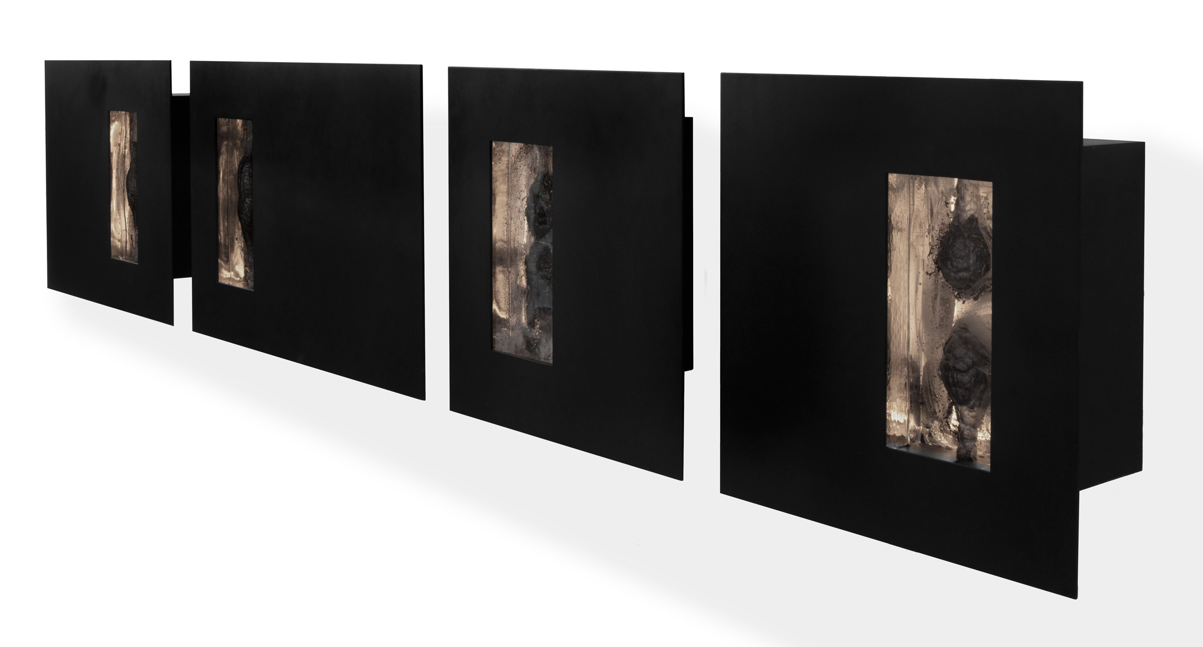 Esrawe Studio blackens glass with burned wood for sculptural lighting set
