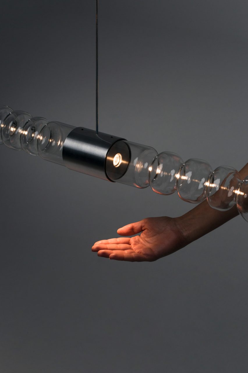 Mayice Studio creates sculptural lamp from curving glass tube