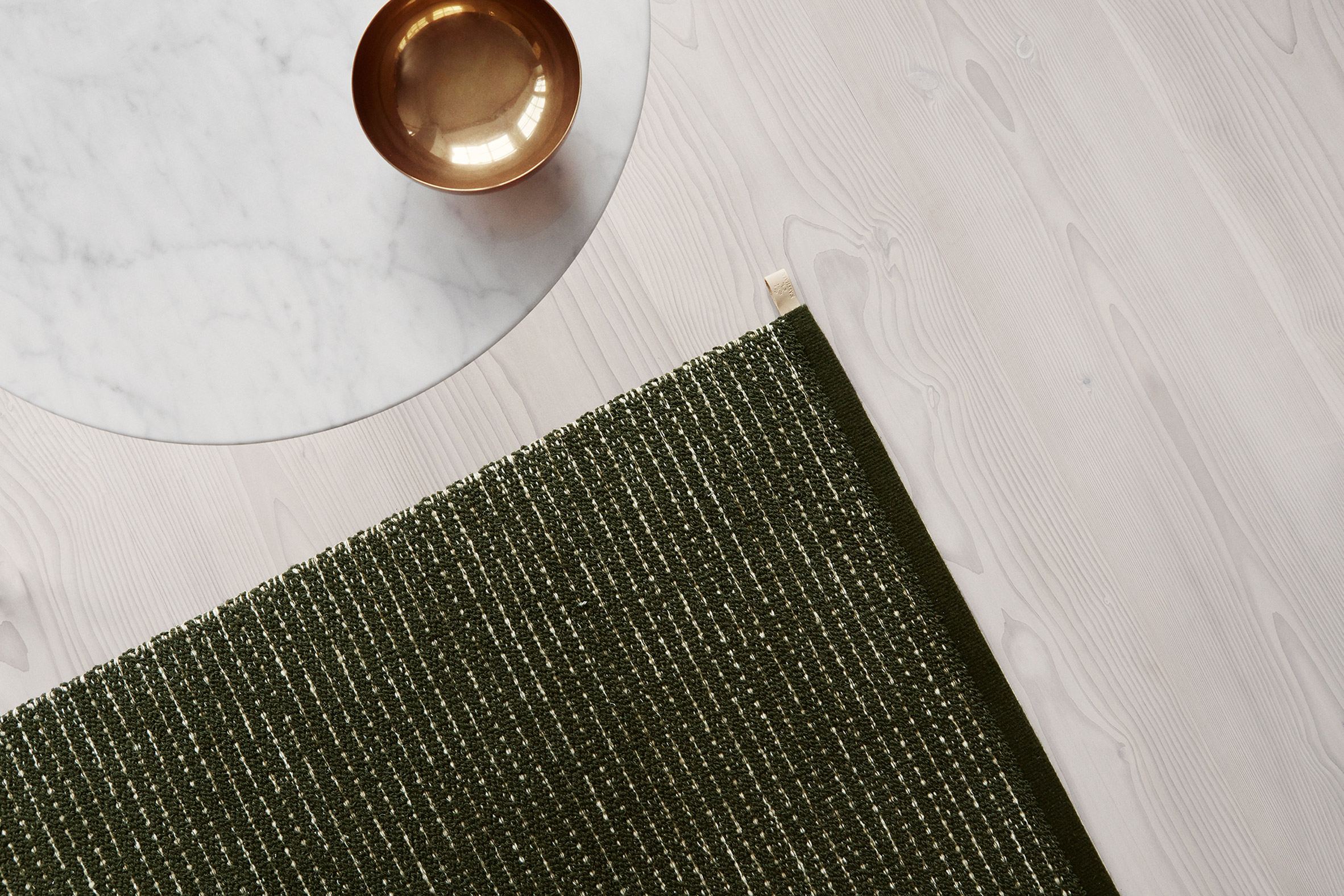 British designer Ilse Crawford was inspired by the natural landscape surrounding the Kasthall factory in Kinna, Västergötland when creating her collection of green rugs for the Swedish textile company.