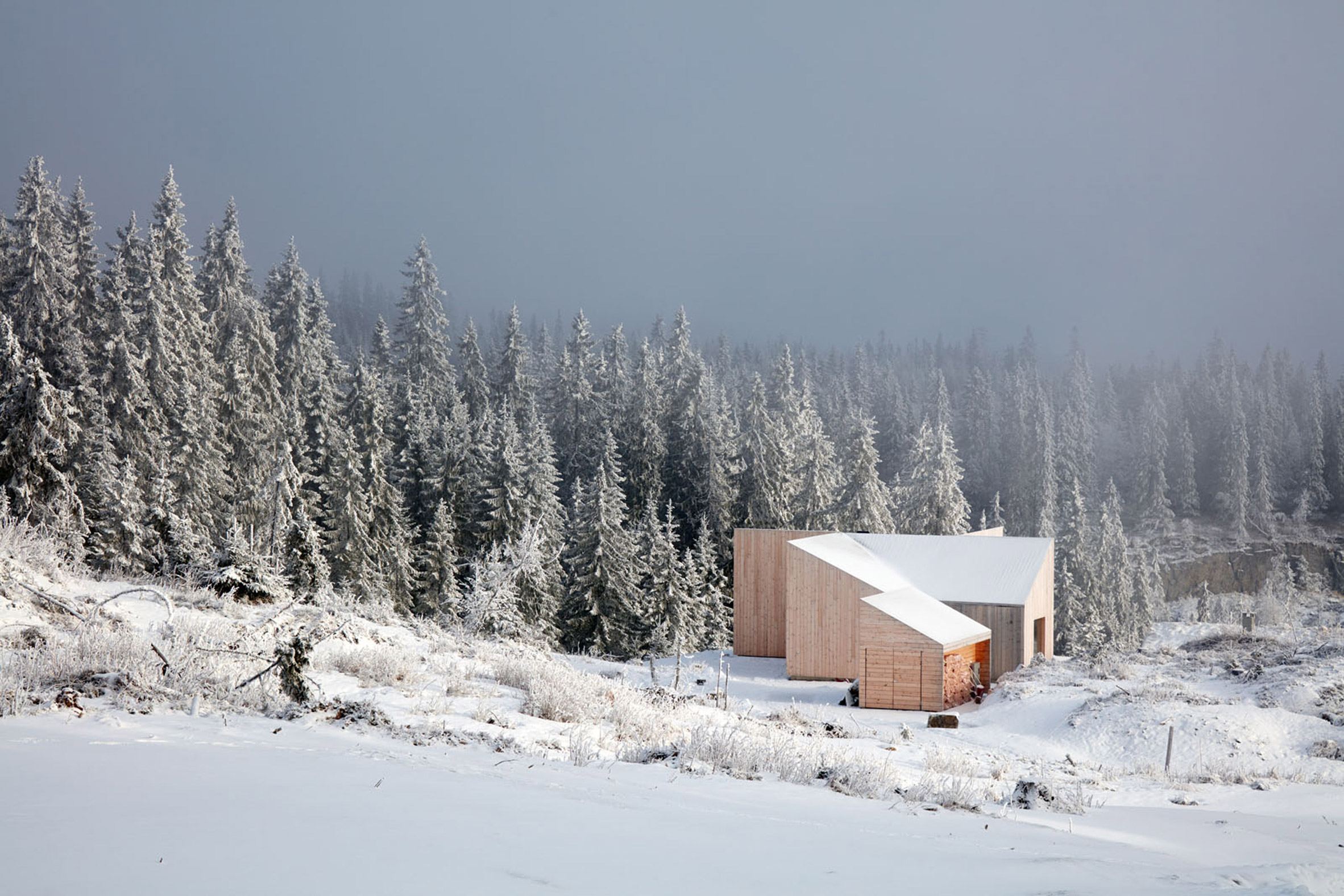 Mork-Ulnes Architects completes timber-clad house with "pinwheel plan" in a Norwegian forest