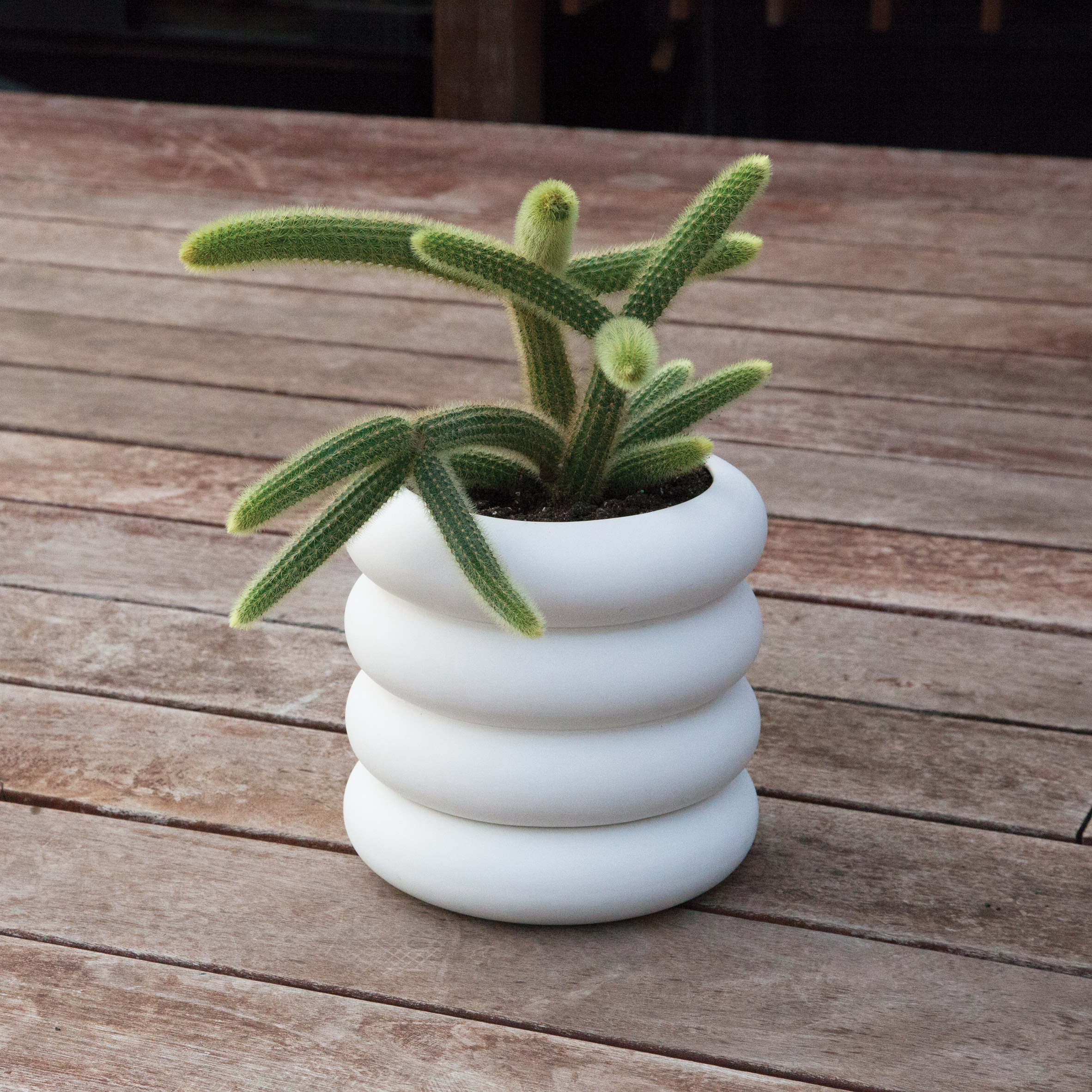 Stacking Planter with tiered volumes conceals built-in water saucer