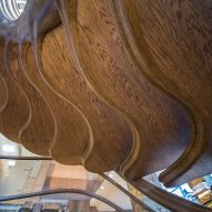 Atmos Studio's spiralling timber staircase features "leaf-like" stairs that emerge from a structural stem