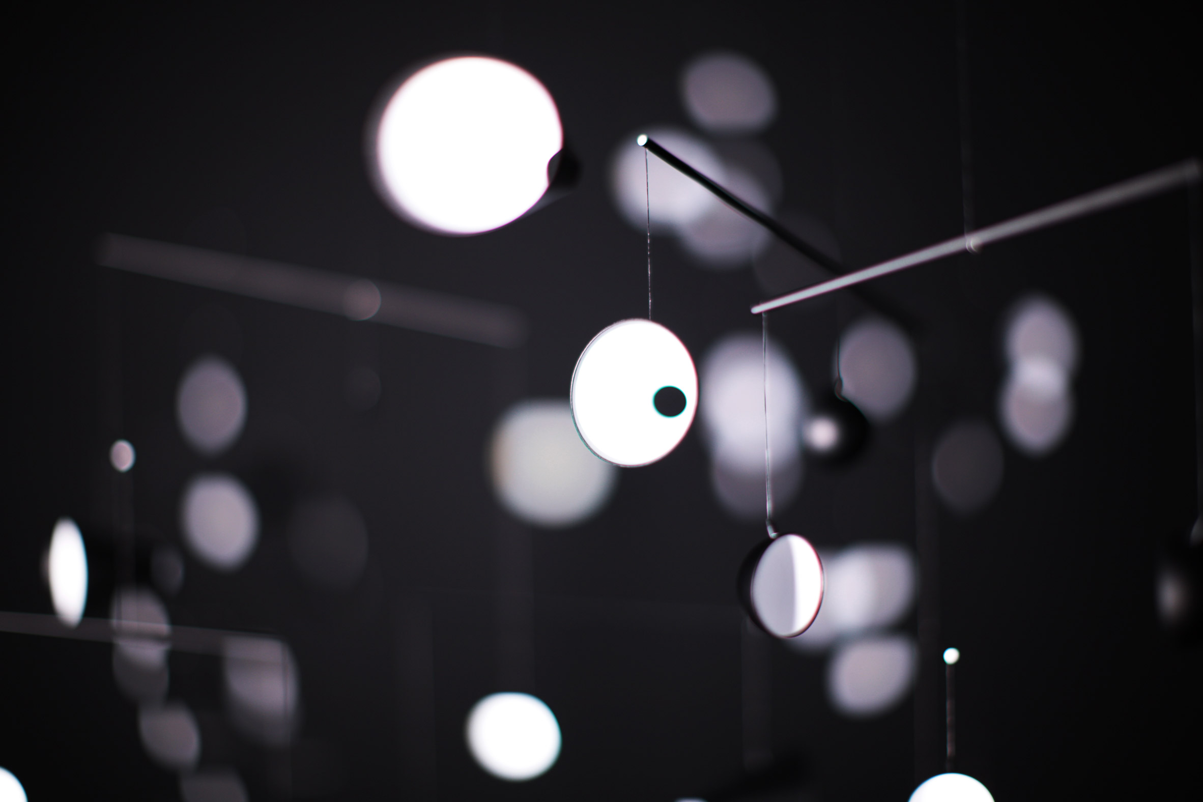 Hiroto Yoshizoe's mirrored mobile reflects light from a single bulb