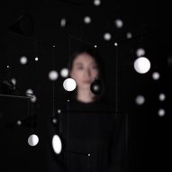 Hiroto Yoshizoe's mirrored mobile 1.625m/s2 reflects light from a single bulb