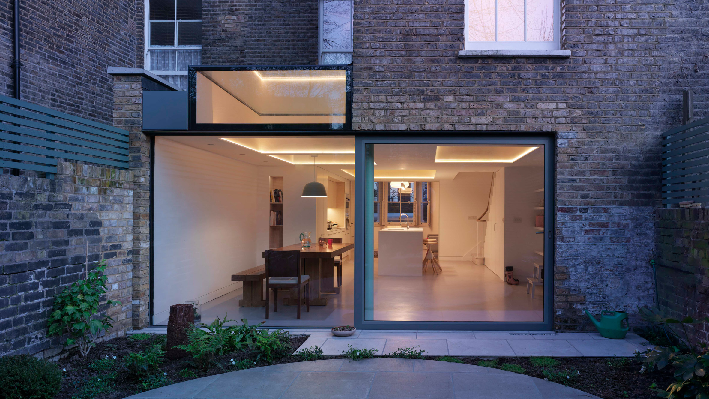 Glazed extension connects refurbished Highbury house with new patio garden
