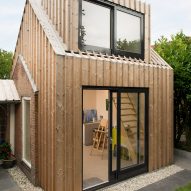 Timber-clad painting studio by Open Kaart wraps around and old brick shed