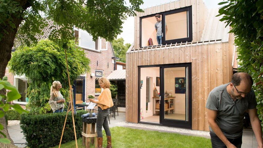 Timber-clad painting studio by Open Kaart wraps around and old brick shed