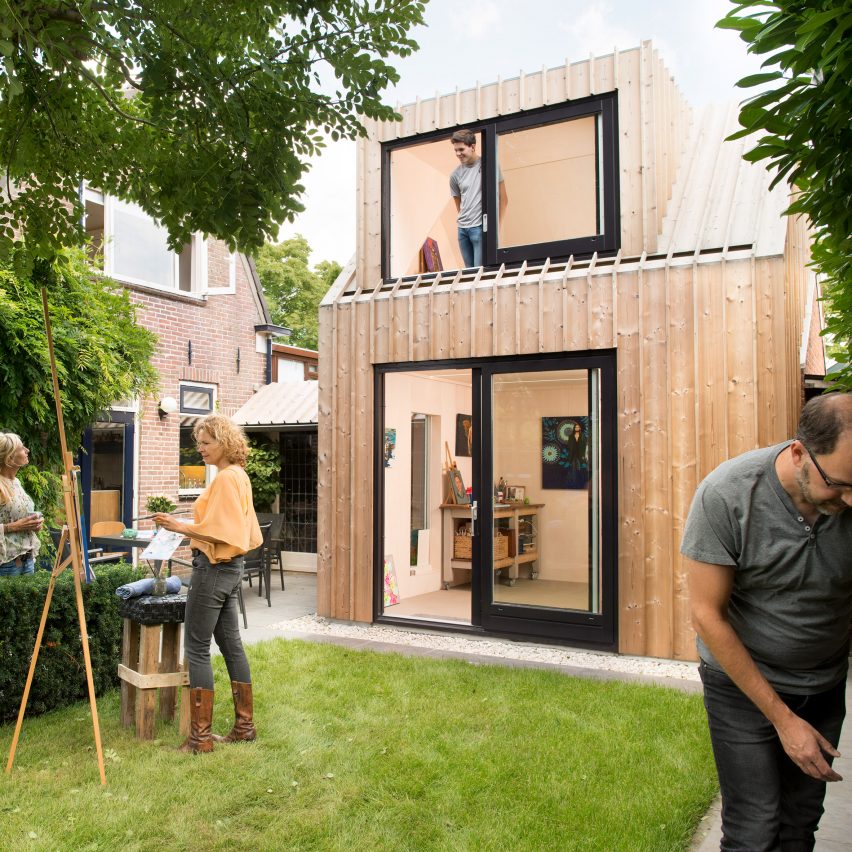 Timber-clad painting studio by Open Kaart wraps around and old brick shed