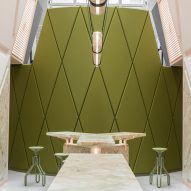 Pink marble surfaces contrast with rich green accents in Ghent's XYZ Lounge bar