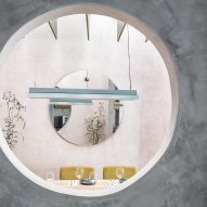 Pastel furnishings contrast against concrete walls in Seville's Casaplata restaurant