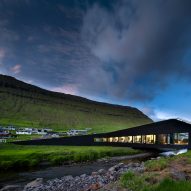 Henning Larsen builds town hall that bridges a river on the Faroe Islands