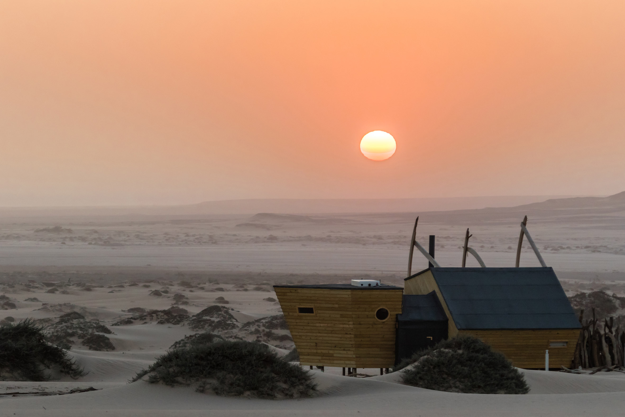 Shipwreck Lodge's wooden cabins evoke ships washed up on Namibia's Skeleton Coast
