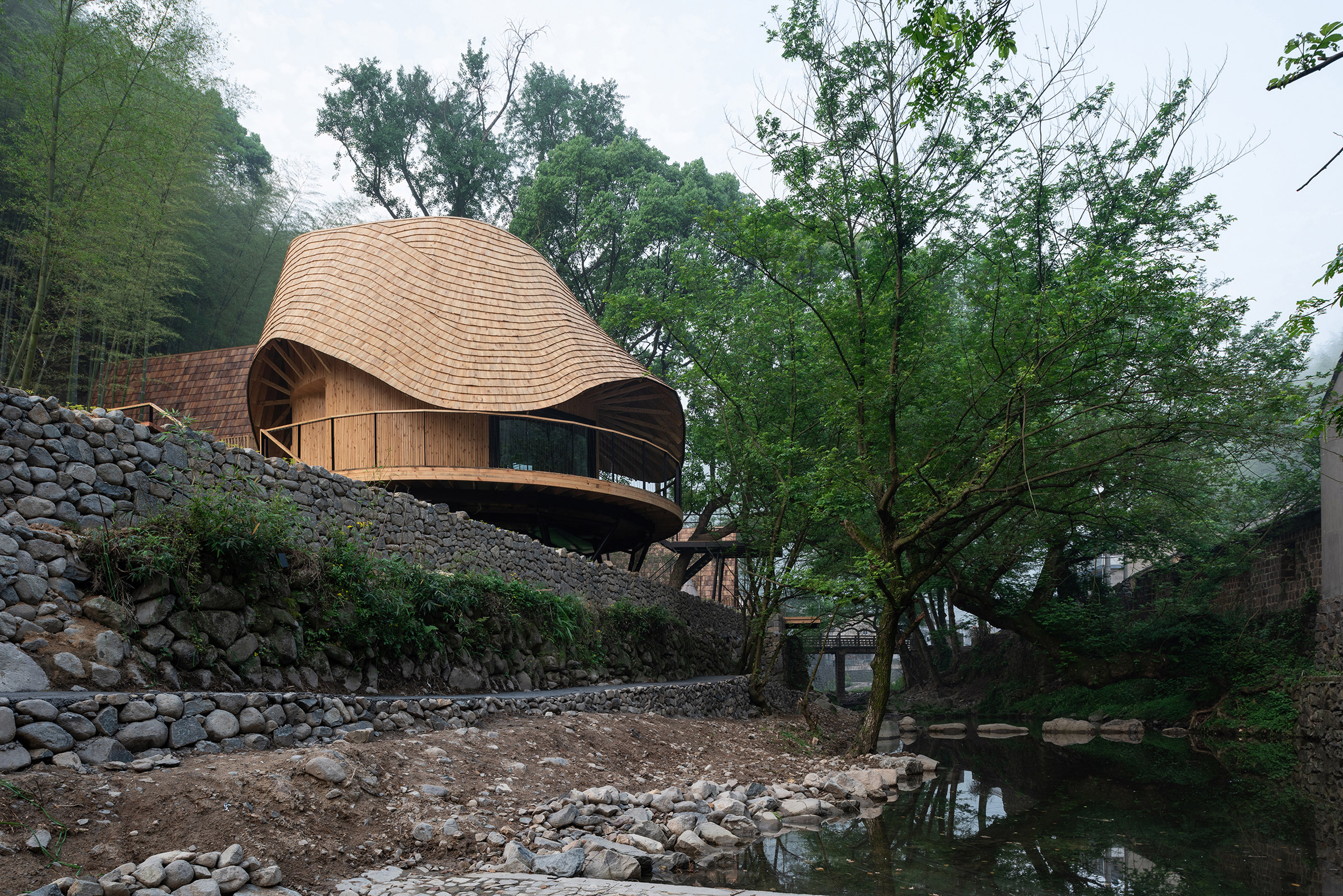 Treewow Retreat is a Chinese village house featuring a round freeform roof