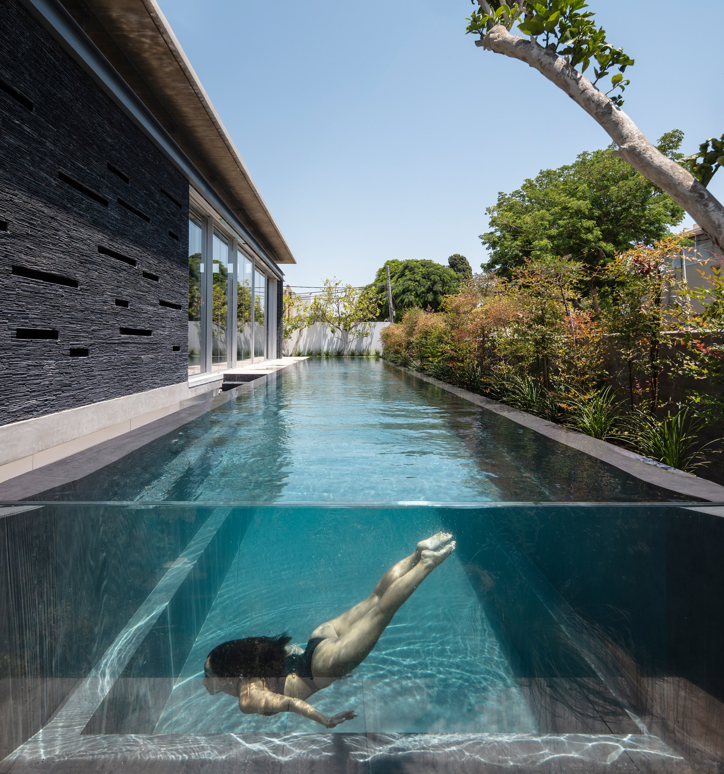 Linear pool parallels slate Pavilion House in Israel by Pitsou Kedem