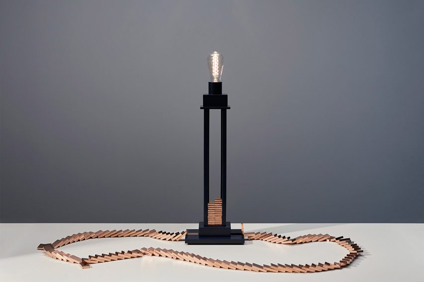 Glithero's interactive lamp is illuminated by a toppling row of dominoes
