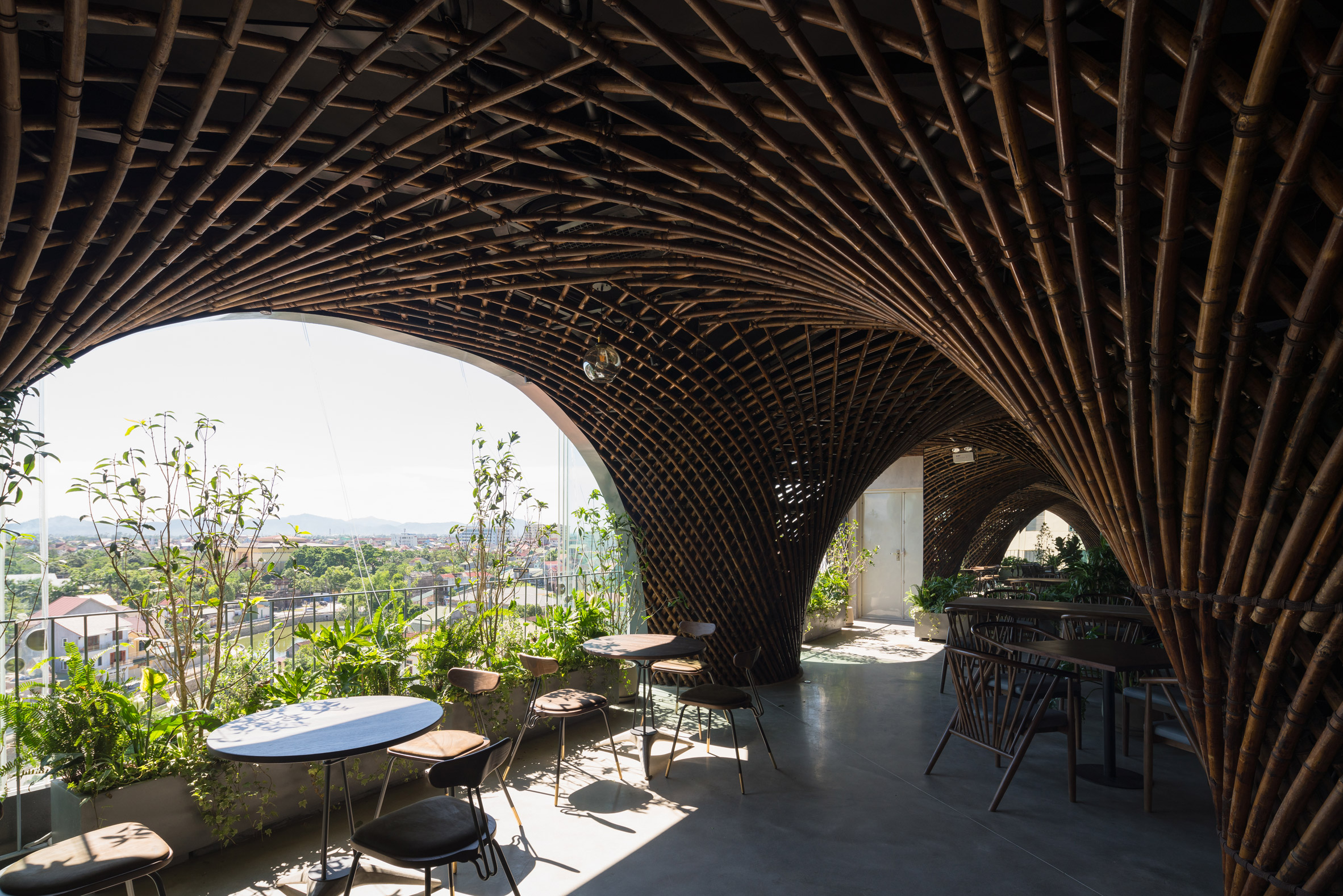 Vo Trong Nghia Architects creates "cave-like" Nocenco cafe with swirling bamboo ceiling