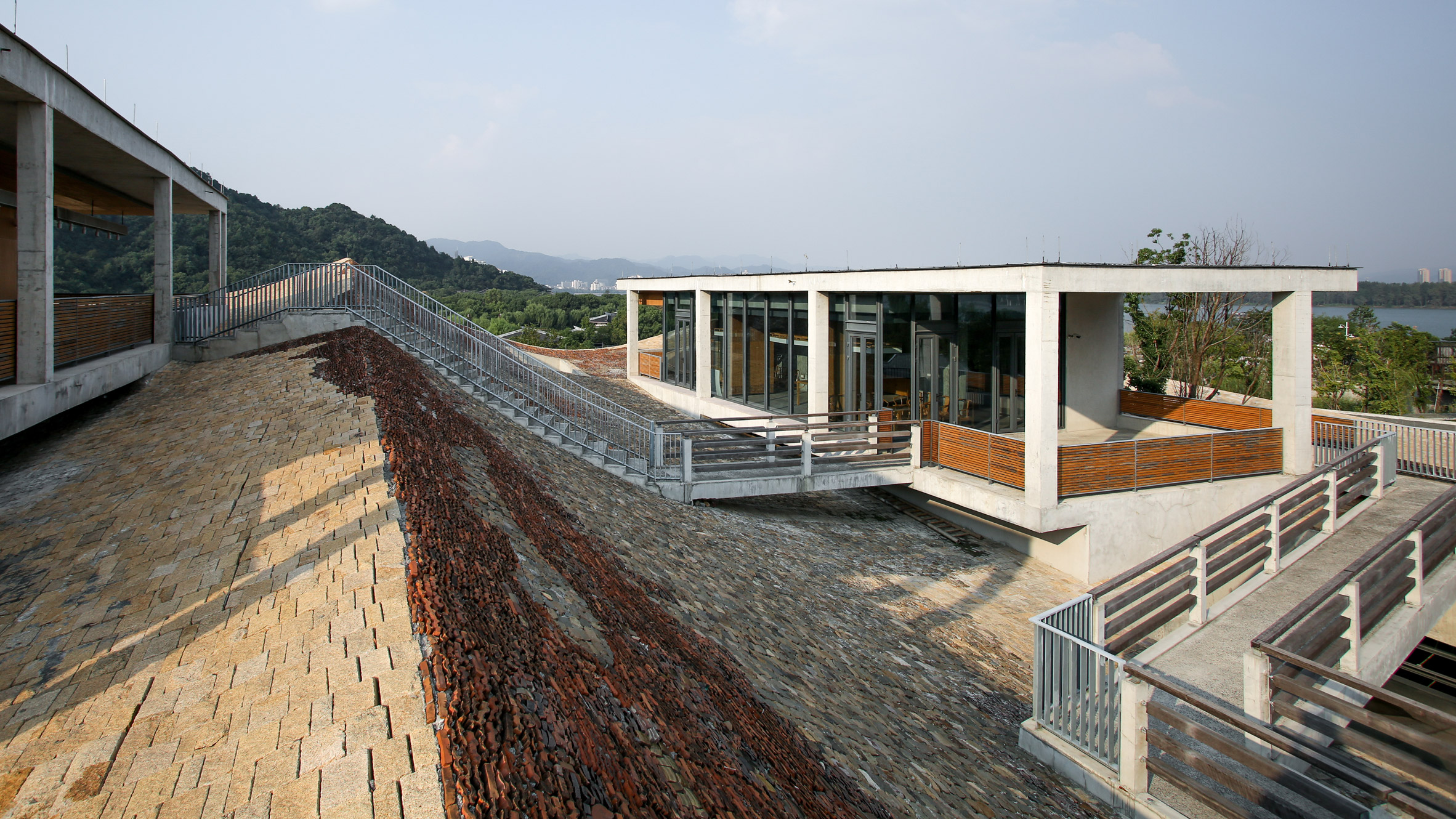 Wave-shaped roof of recycled tiles tops Wang Shu's Fuyang Cultural