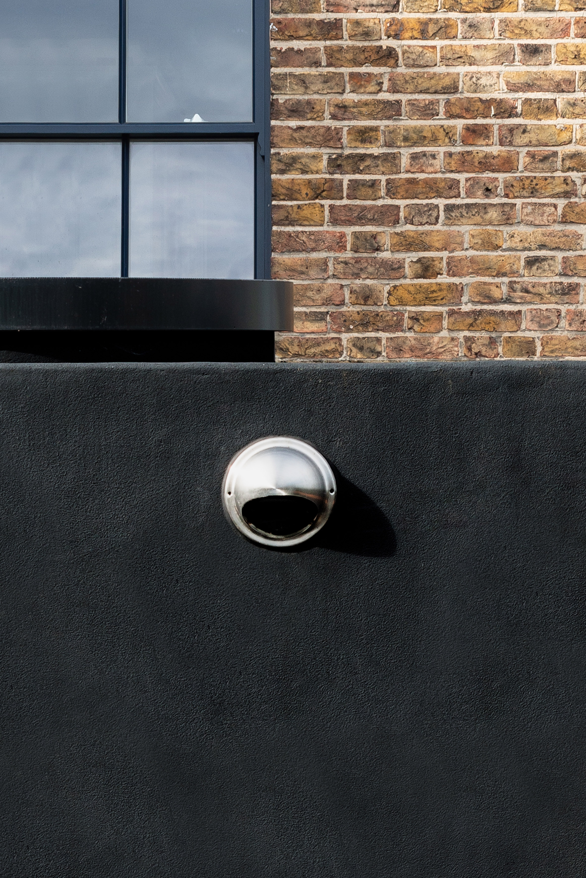 Office S&M's "two-faced" Janus House extension is coated with spray-on rubber