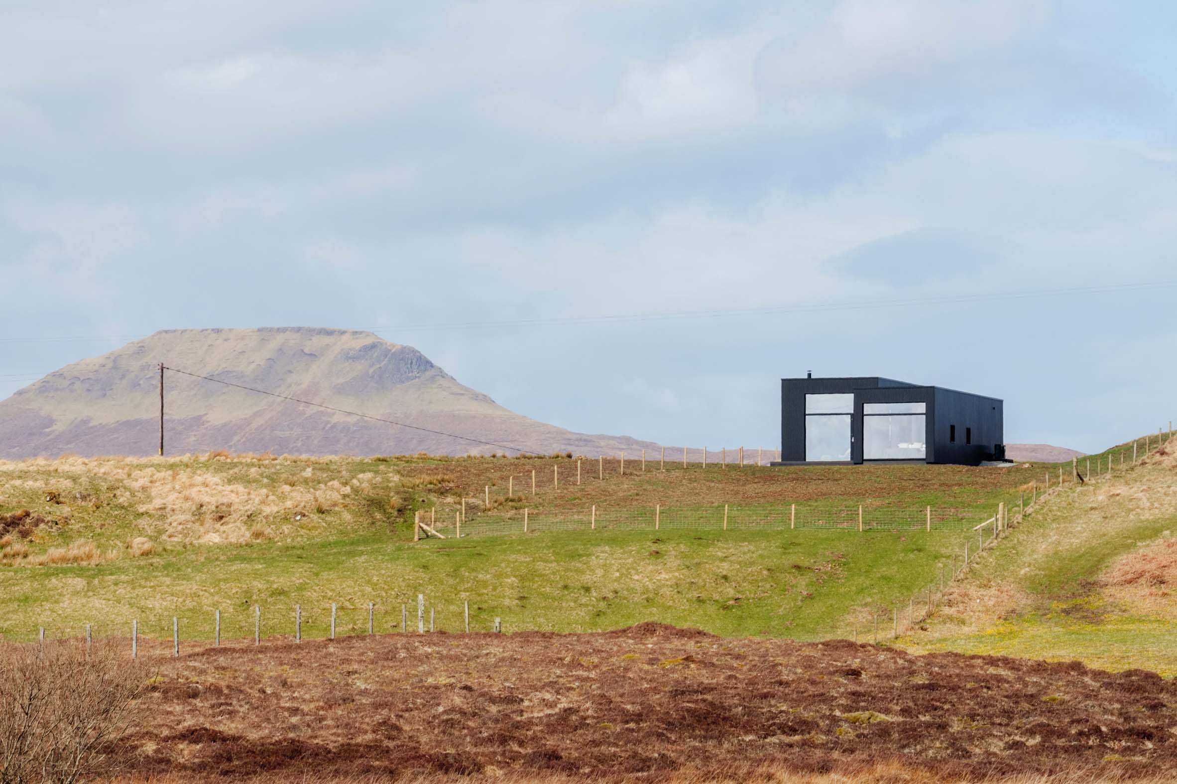 Dualchas Architects creates minimalist blackened-oak hideaway on Scotland's Isle of Skye