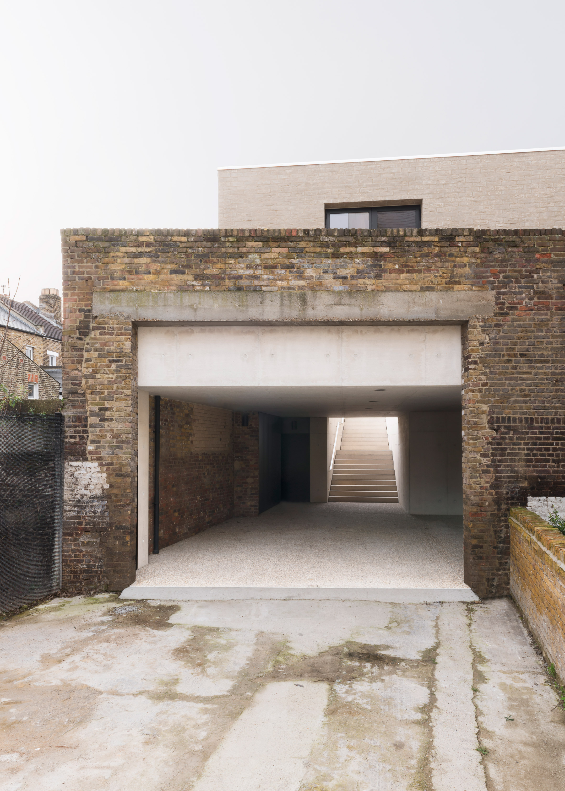 Carmody Groarke inserts concrete house inside old brick warehouse in London