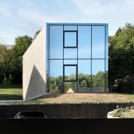 2001 creates concrete house and reflective glass house in suburban Luxembourg